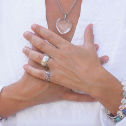 Hands resting over heart symbolizing mindfulness and emotional grounding
