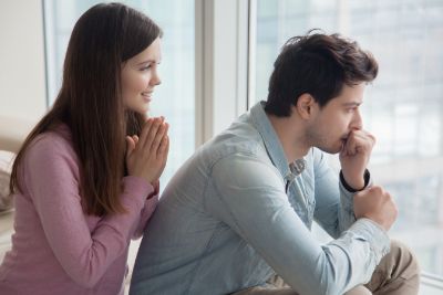 Woman comforting a man who appears stressed or overwhelmed