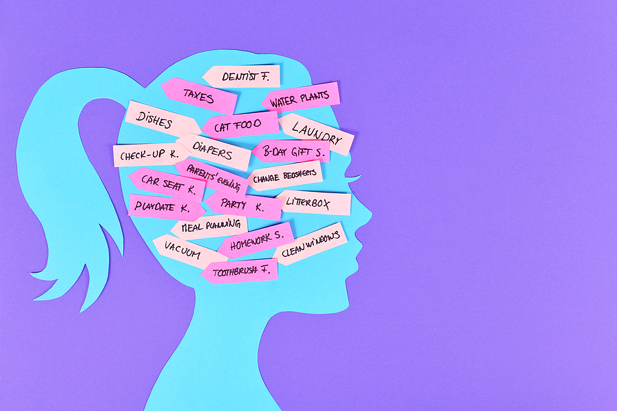 Silhouette of a woman’s head filled with colorful sticky notes listing household and family tasks — laundry, dishes, meal planning, birthdays, appointments — illustrating the invisible mental load many women carry.